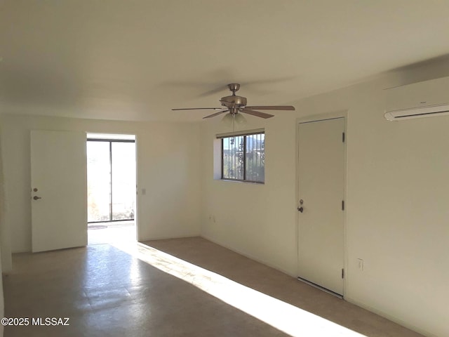 spare room featuring ceiling fan and a wall mounted AC