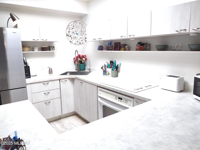 kitchen featuring sink and white appliances