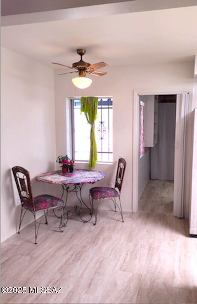 dining room with breakfast area, ceiling fan, and light hardwood / wood-style flooring