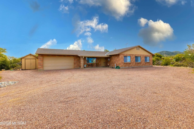 view of front of house with a garage and a storage unit