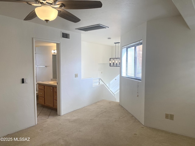 5675 N Camino Esplendora Unit 5228, Tucson, AZ 85718 - unfurnished room featuring light colored carpet, ceiling fan, a chandelier, and a sink