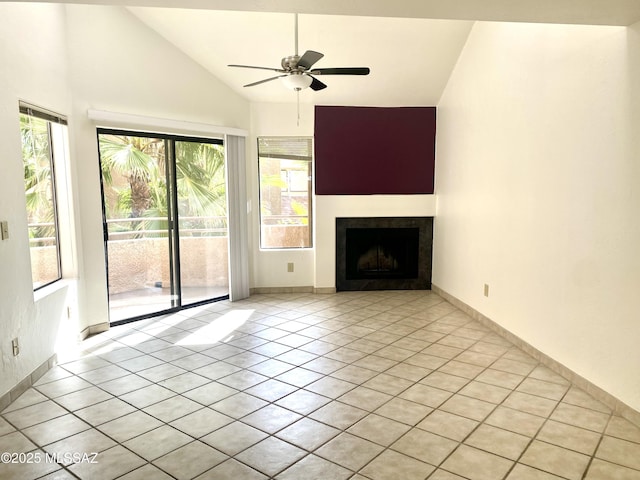 unfurnished living room featuring high vaulted ceiling, ceiling fan, a tiled fireplace, and light tile patterned floors