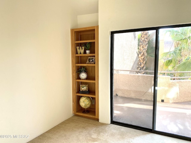 doorway featuring light carpet