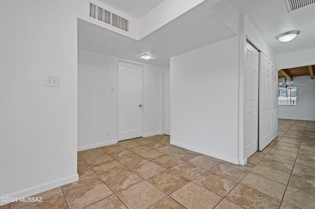 unfurnished room featuring light tile patterned flooring