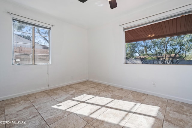 empty room featuring light tile patterned floors and ceiling fan