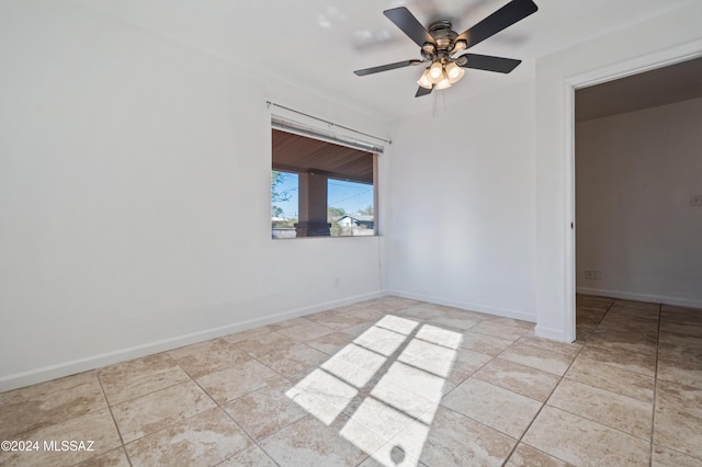 unfurnished room with ceiling fan and light tile patterned floors