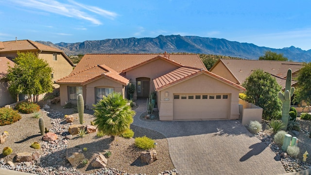 view of front facade with a mountain view and a garage