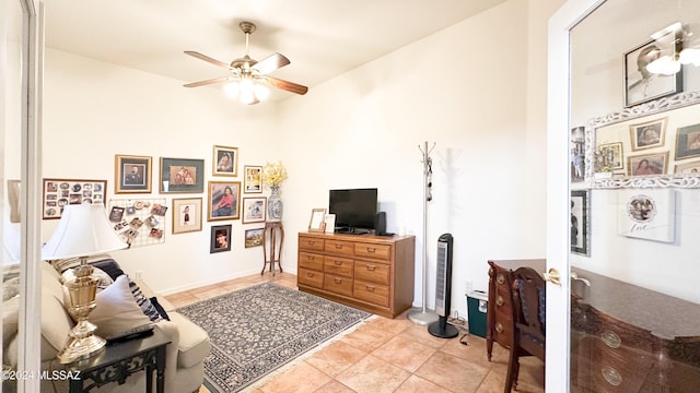 tiled living room featuring ceiling fan