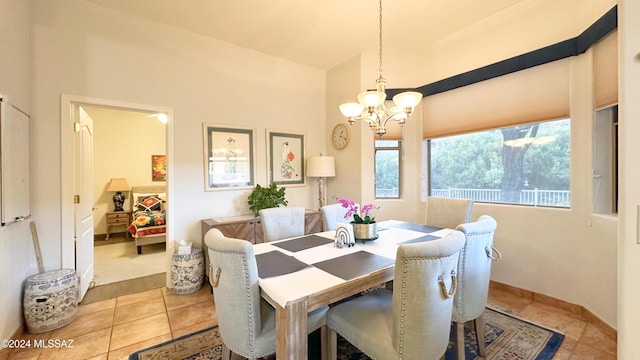 dining space featuring light tile patterned floors and a notable chandelier