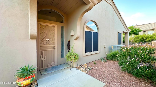 doorway to property featuring central air condition unit