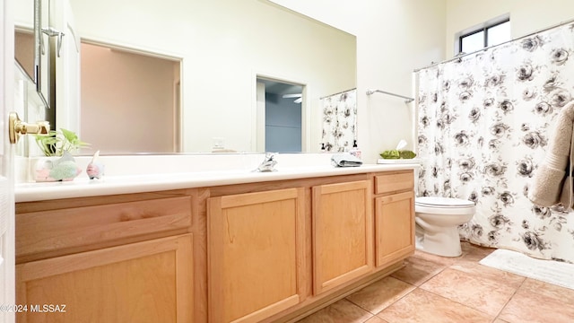 bathroom featuring tile patterned flooring, vanity, and toilet