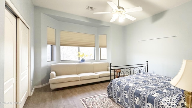 bedroom with hardwood / wood-style floors, a closet, and ceiling fan