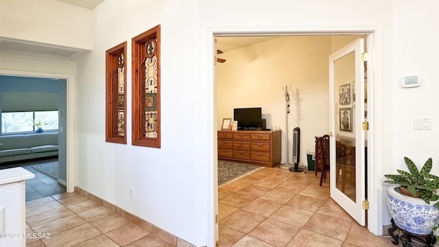 hall featuring light tile patterned flooring