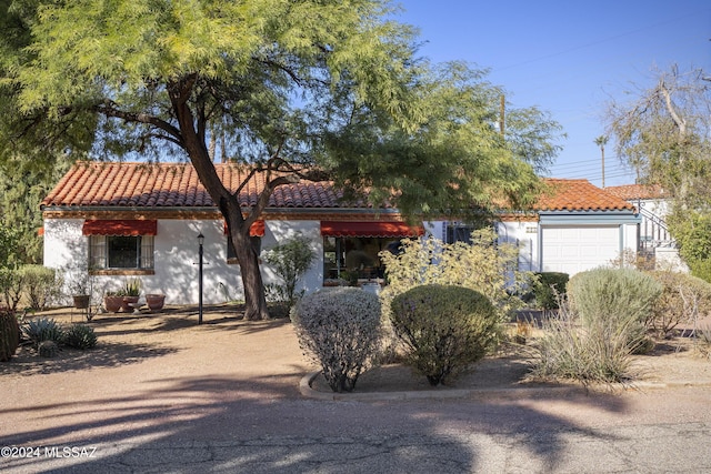 mediterranean / spanish-style house with a garage