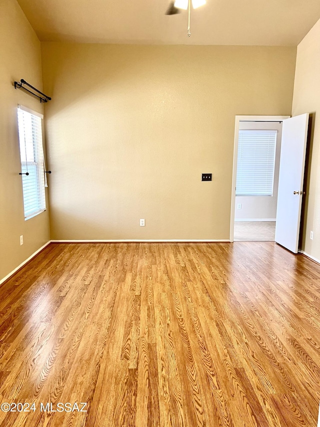 spare room featuring light wood-type flooring and ceiling fan