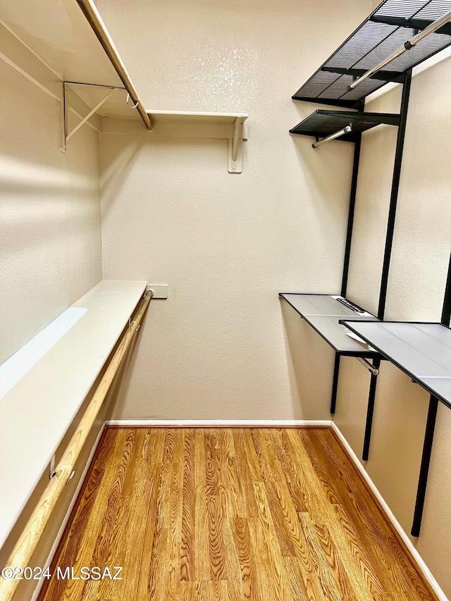 walk in closet featuring light hardwood / wood-style flooring