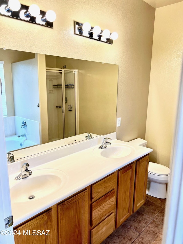 full bathroom featuring tile patterned floors, vanity, plus walk in shower, and toilet