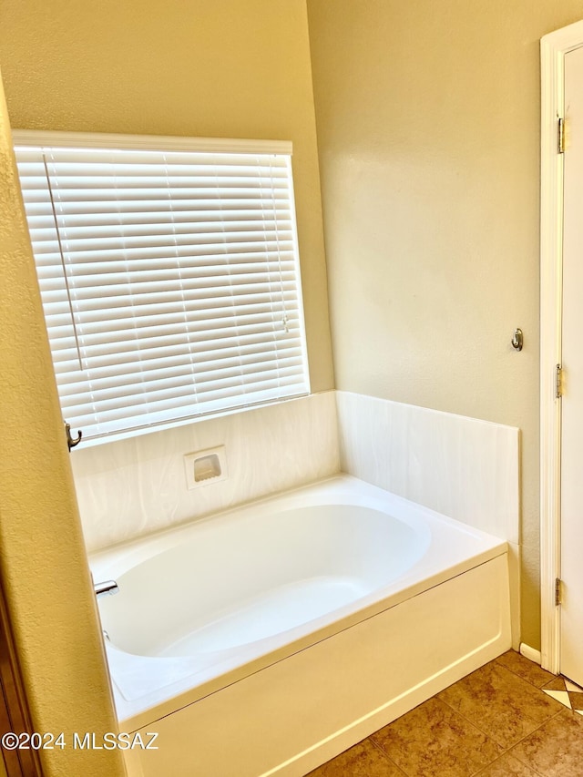 bathroom featuring tile patterned floors and a tub