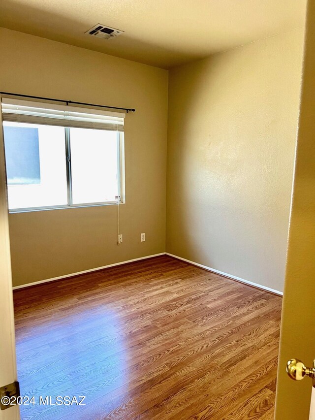 spare room featuring hardwood / wood-style floors