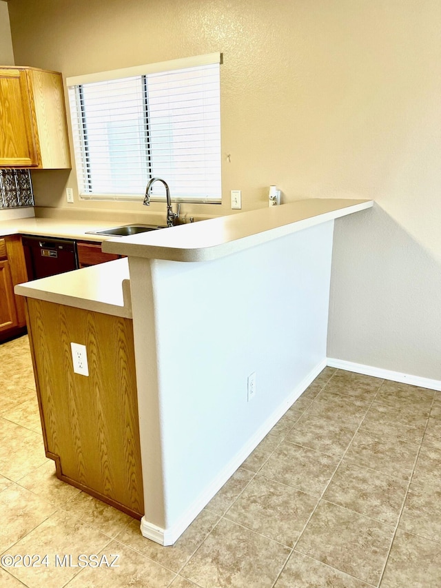 kitchen with black dishwasher, kitchen peninsula, sink, and light tile patterned floors