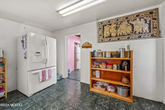 kitchen with white refrigerator with ice dispenser