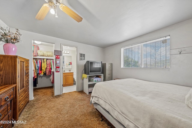 carpeted bedroom featuring connected bathroom, a spacious closet, a closet, and ceiling fan