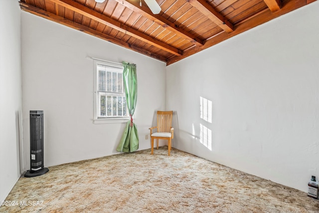 carpeted empty room featuring beam ceiling, ceiling fan, and wood ceiling