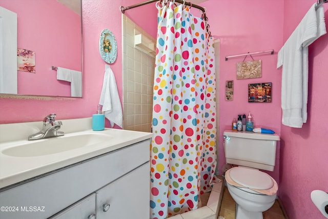 bathroom with tile patterned floors, a shower with curtain, vanity, and toilet