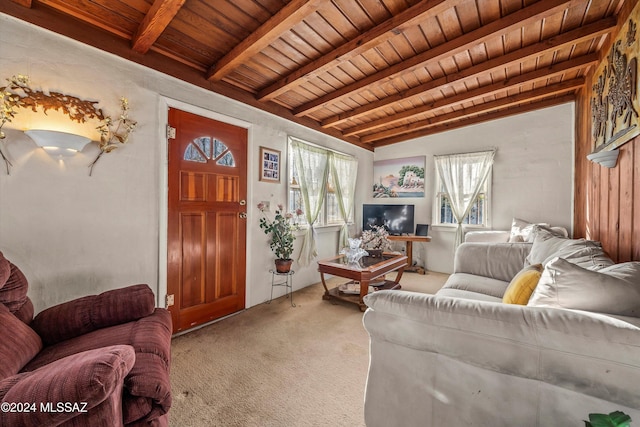 carpeted living room with lofted ceiling with beams and wooden ceiling