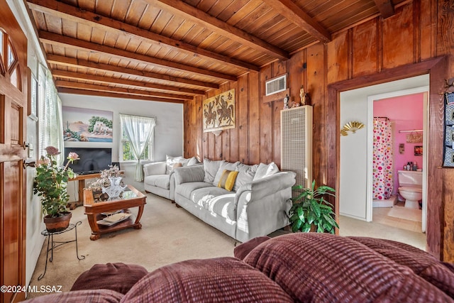 living room featuring beamed ceiling, light carpet, wood ceiling, and wood walls