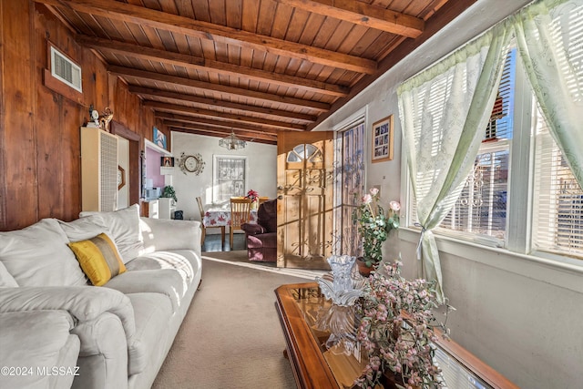 carpeted living room featuring beamed ceiling and wooden ceiling