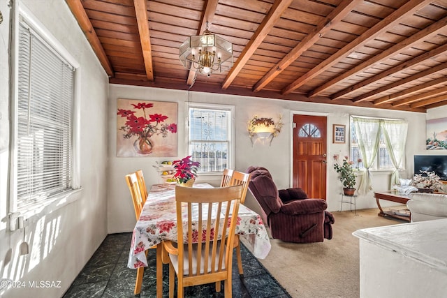 carpeted dining room featuring beam ceiling, wood ceiling, and a chandelier