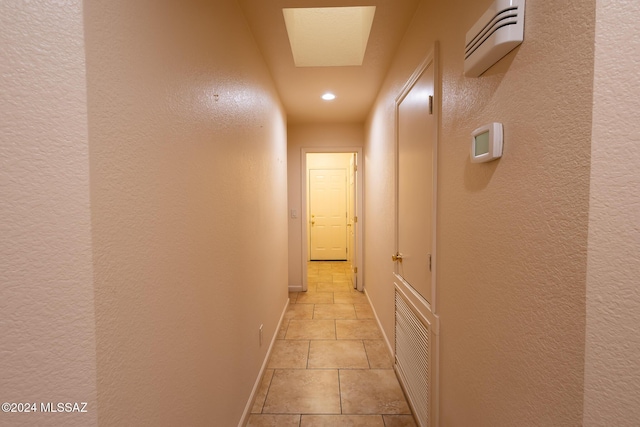 corridor with light tile patterned floors