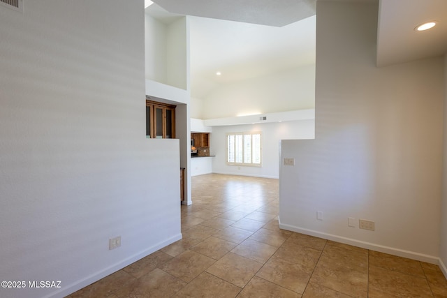 spare room with visible vents, high vaulted ceiling, recessed lighting, light tile patterned floors, and baseboards