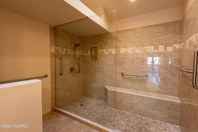 bathroom with a tile shower