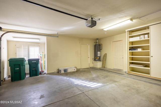 garage featuring a garage door opener and water heater