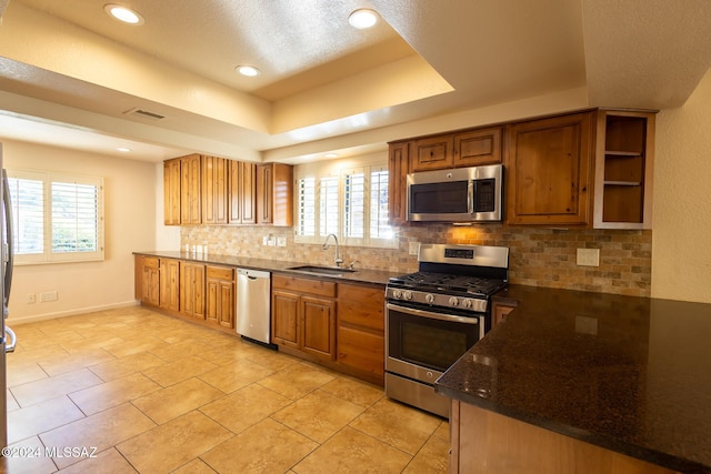 kitchen featuring plenty of natural light, sink, stainless steel appliances, and tasteful backsplash