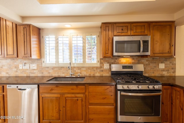 kitchen with stainless steel appliances, tasteful backsplash, and sink