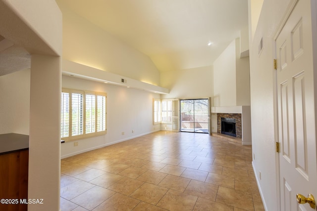 unfurnished living room featuring visible vents, high vaulted ceiling, a fireplace with raised hearth, light tile patterned floors, and baseboards