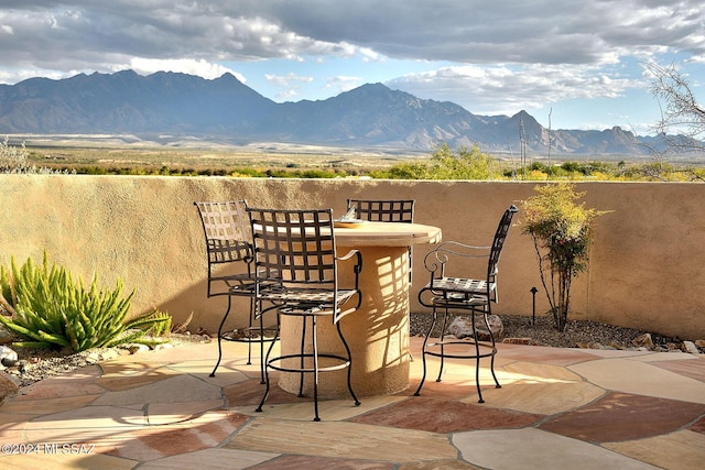 view of patio / terrace featuring a mountain view and an outdoor bar