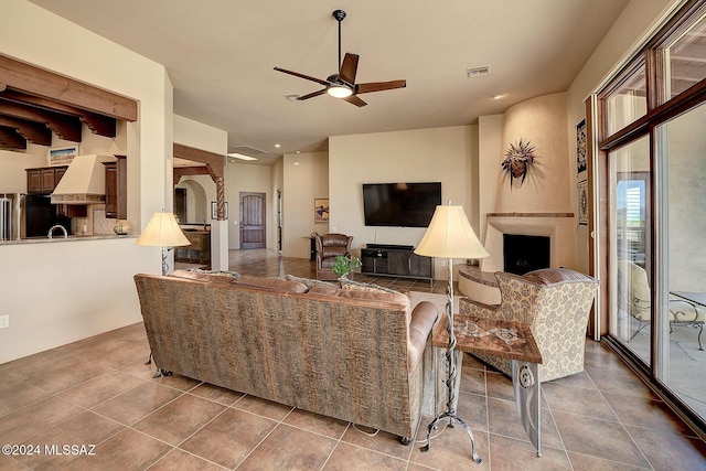 living room with tile patterned floors and ceiling fan