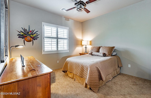 bedroom featuring light carpet and ceiling fan