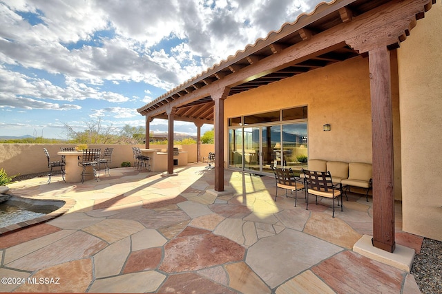 view of patio / terrace with outdoor lounge area and exterior bar