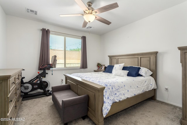 bedroom featuring a ceiling fan, visible vents, light carpet, and baseboards