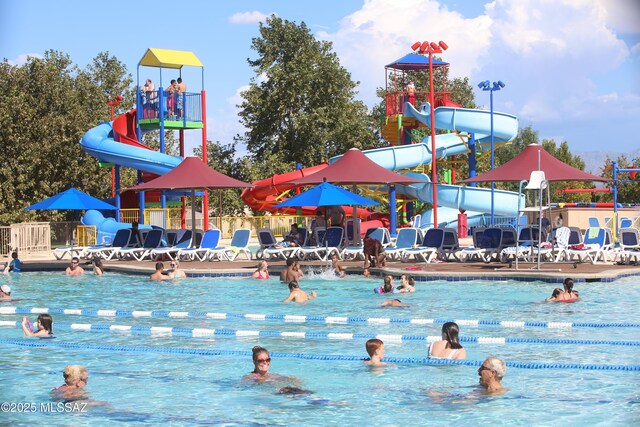 view of swimming pool with playground community