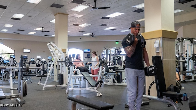 gym with ceiling fan and a drop ceiling