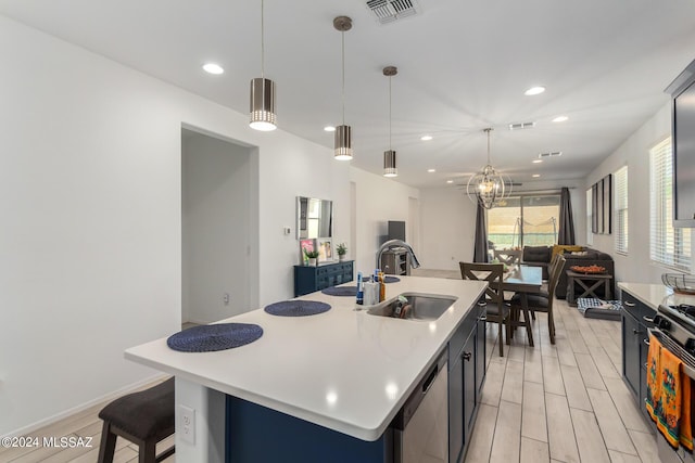 kitchen featuring light countertops, a kitchen island with sink, dishwasher, and visible vents