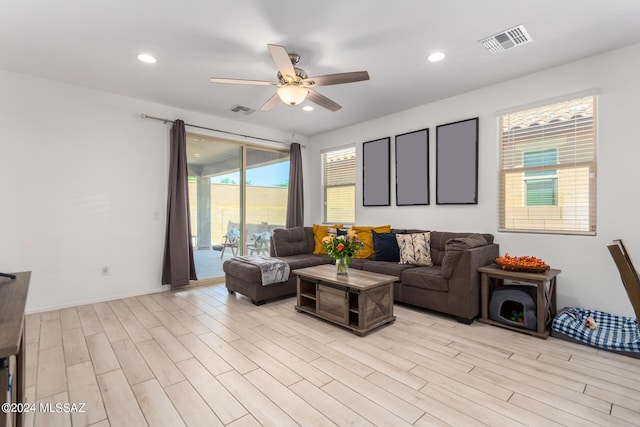 living room featuring ceiling fan, recessed lighting, visible vents, and light wood-style floors