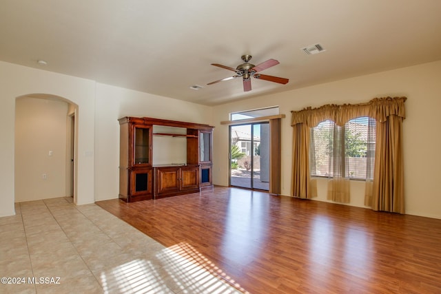 unfurnished living room featuring light wood-type flooring and ceiling fan