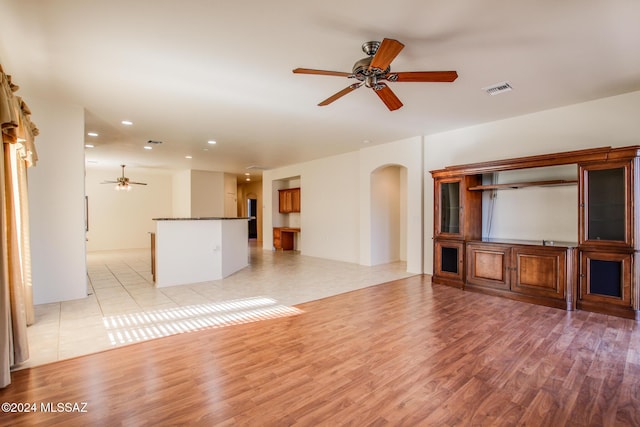 unfurnished living room with light hardwood / wood-style floors and ceiling fan